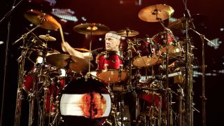 Neil Peart behind Red Sparkle DW kit during Rush's 2002 World Tour