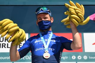 Mark Cavendish holding two bunches of bananas