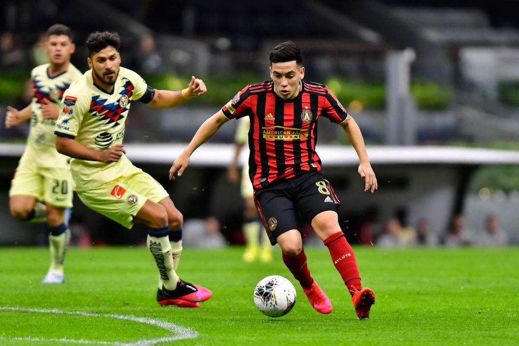 Esequiel Barco (R) of Atlanta United drives the ball against Bruno Valdez (L) of America during a quarter final first leg match between Club America and Atlanta United as part of CONCACAF Champions League 2020 at Azteca on March 11, 2020 in Mexico City, Mexico