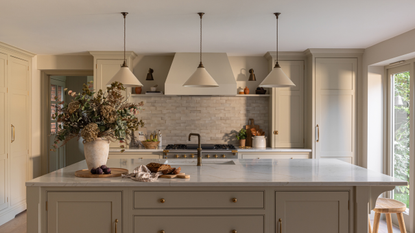 a large kitchen island in an off-white room with flowers on the counters