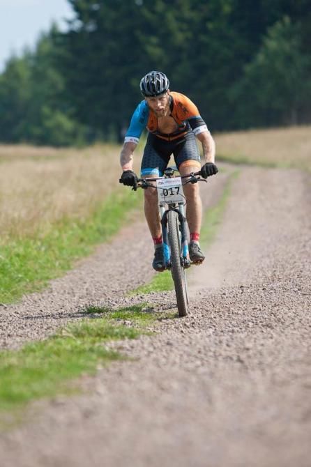 A rider flies along a gravel road.