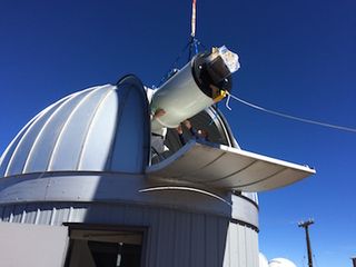 ATLAS#1 telescope gently lowered into Haleakala observatory.