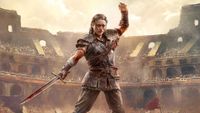 Promotional key art of Path of Exile 2. A man stands in a gladiator arena wielding a bloody sword.