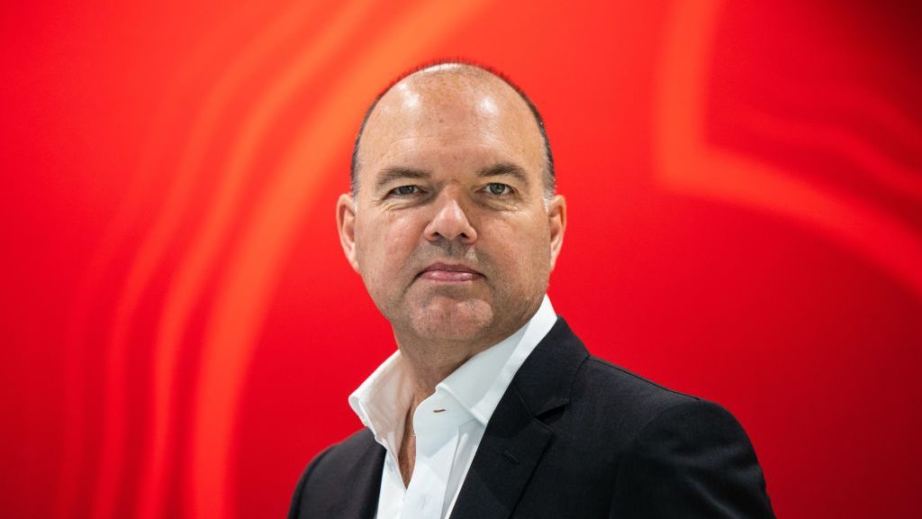 Vodafone CEO Nick Read standing in front of the company&amp;#039;s logo