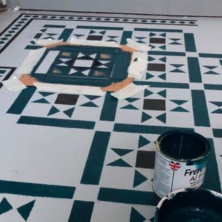 stencil design on floor with hand painting