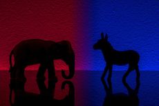 Democrats vs republicans are facing off in a ideological duel on blue and red backgrounds. I