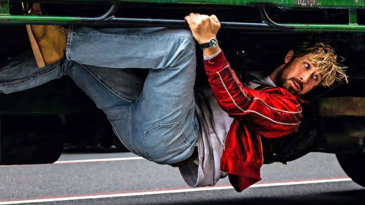 Ryan Gosling clinging to the underside of a truck in Universal Pictures&#039; &#039;The Fall Guy&#039; (2024)