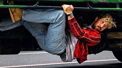 Ryan Gosling clinging to the underside of a truck in Universal Pictures' 'The Fall Guy' (2024)