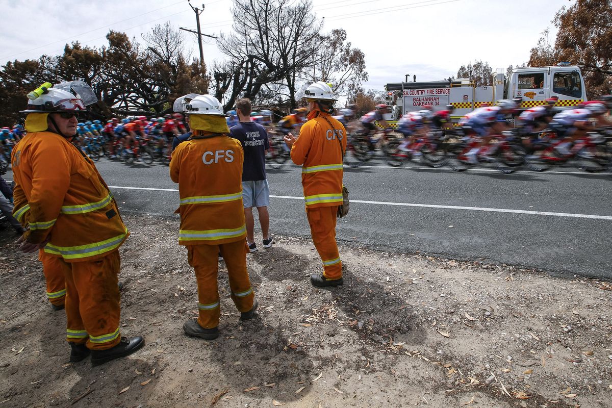 Members of the Country Fire Service cheer the riders en route between Woodside and Stirling on stage 2
