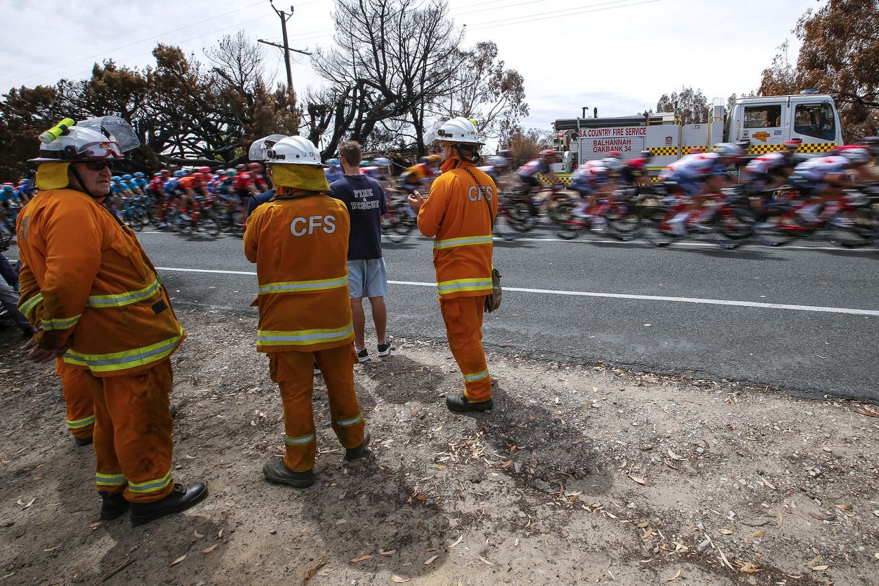 Members of the Country Fire Service cheer the riders en route between Woodside and Stirling on stage 2