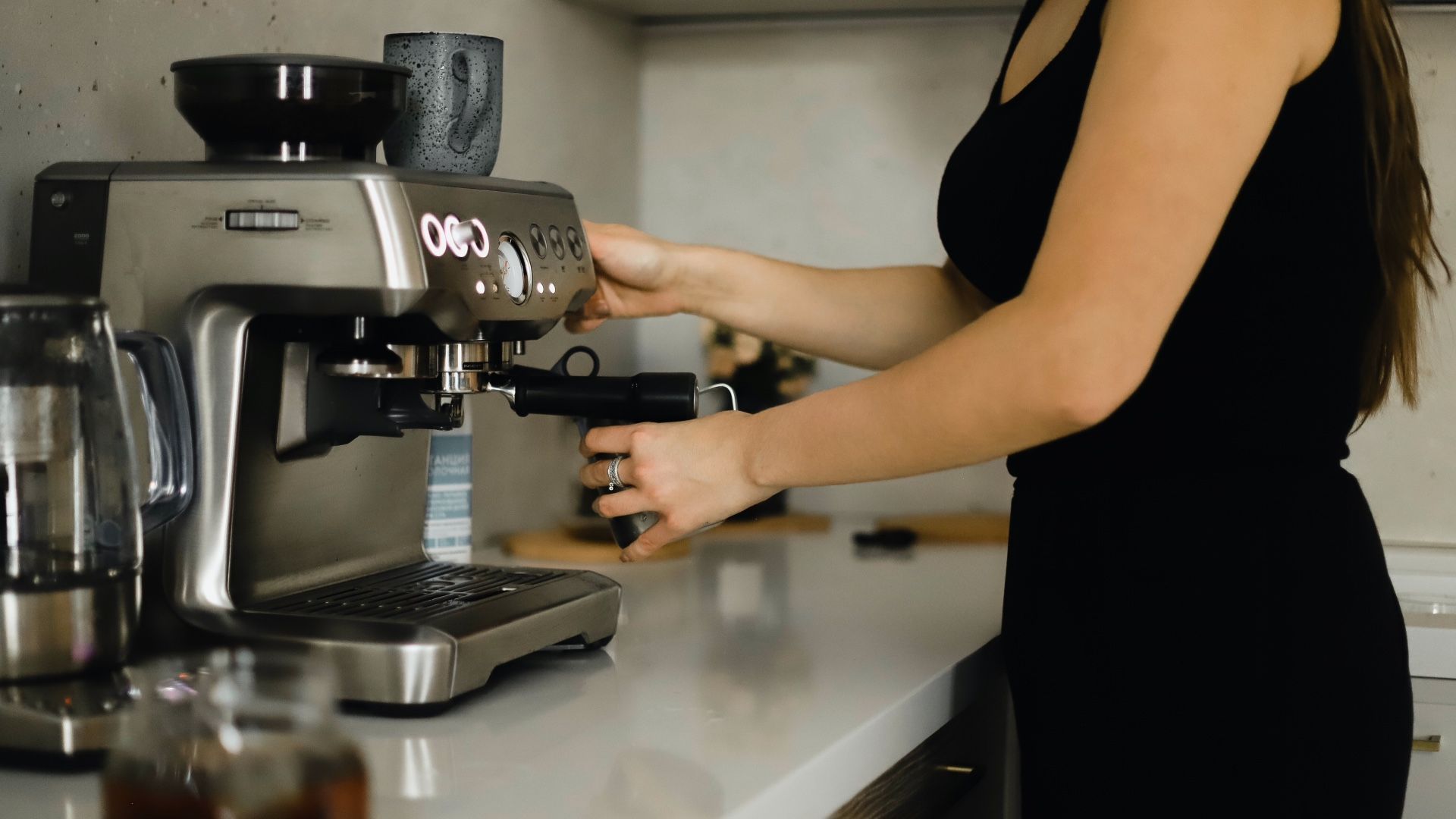 woman using coffee machine at home