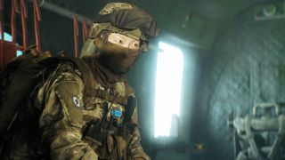 Battlefield 6 Redsec battle royale: A NATO soldier wearing full armour and a face mask sat down inside a helicopter.