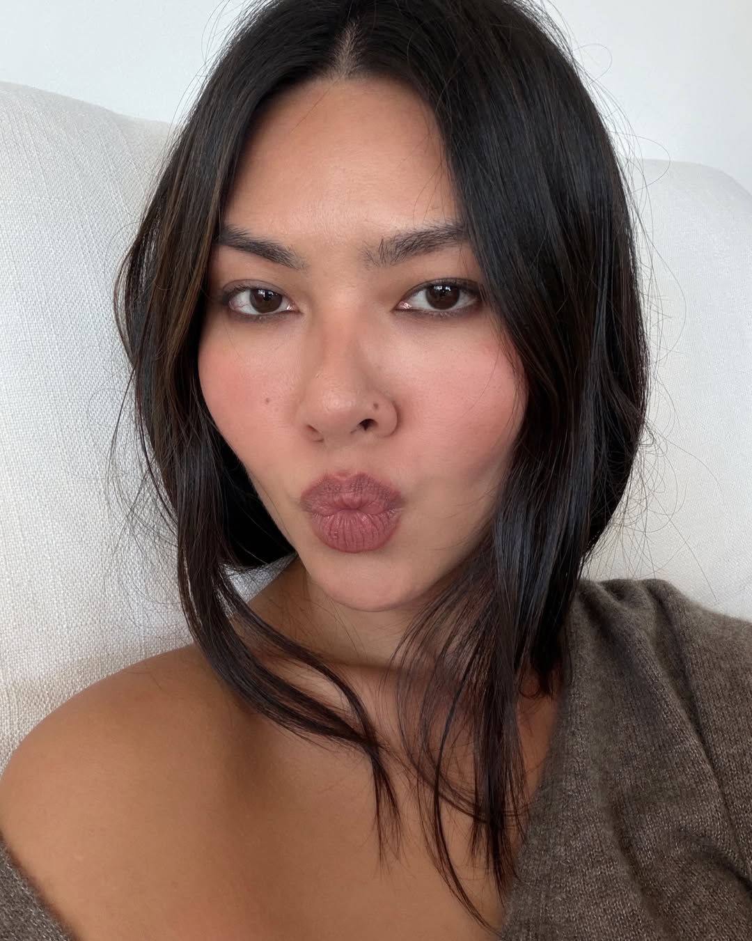 Mimi Nguyen poses with matte mauve lips, flushed cheeks, and smoky eyes