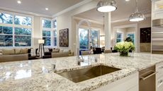 Cream kitchen with granite countertops and novelty tap