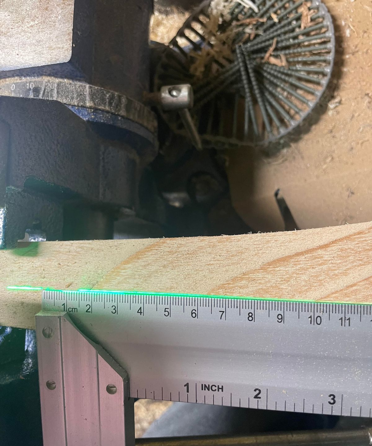 A ruler showing a straight line on a block of wood