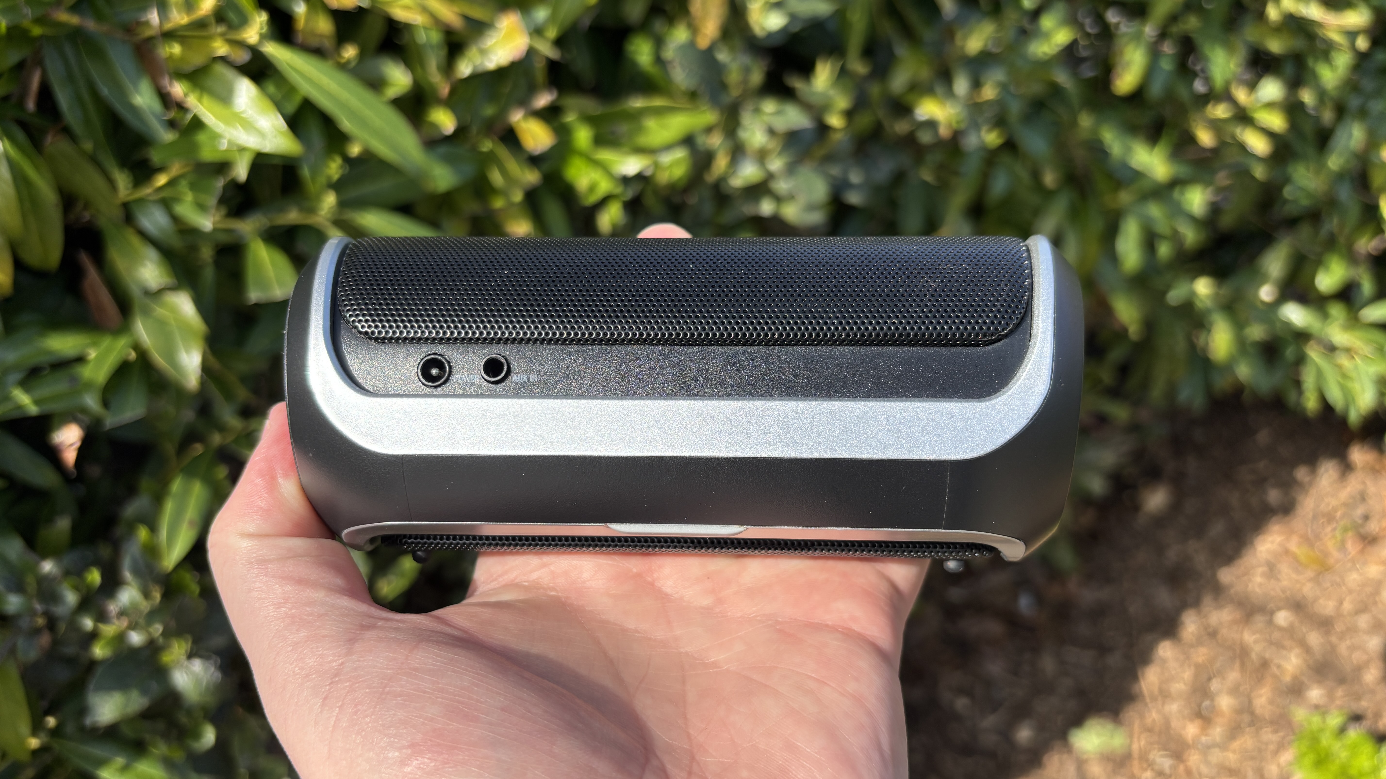 Rear picture of the original JBL Flip in a man's hand