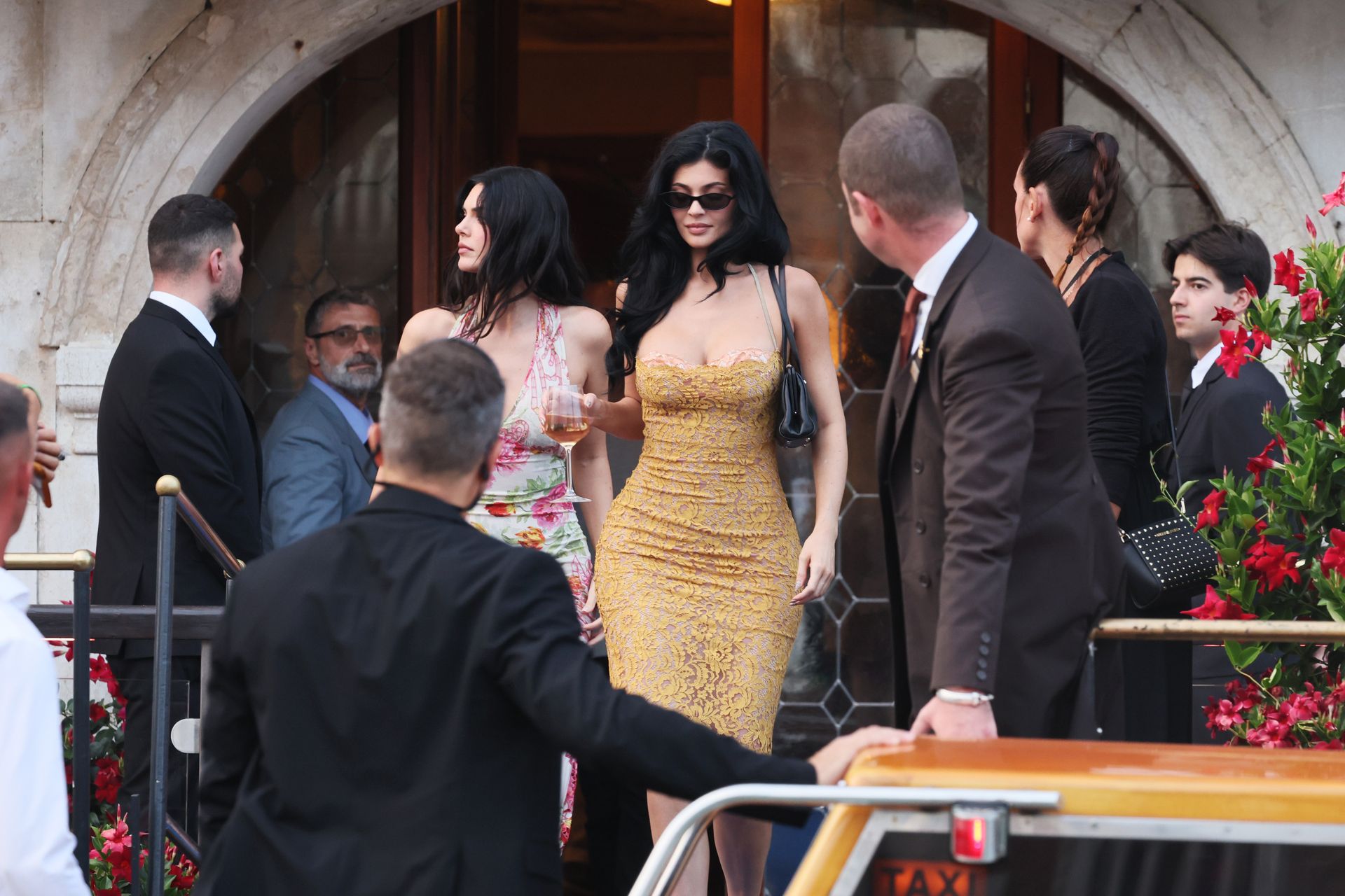 Kylie jenner wears a lace dress in gold.