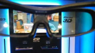 A set of 3D glasses in front of a 2010 3D TV