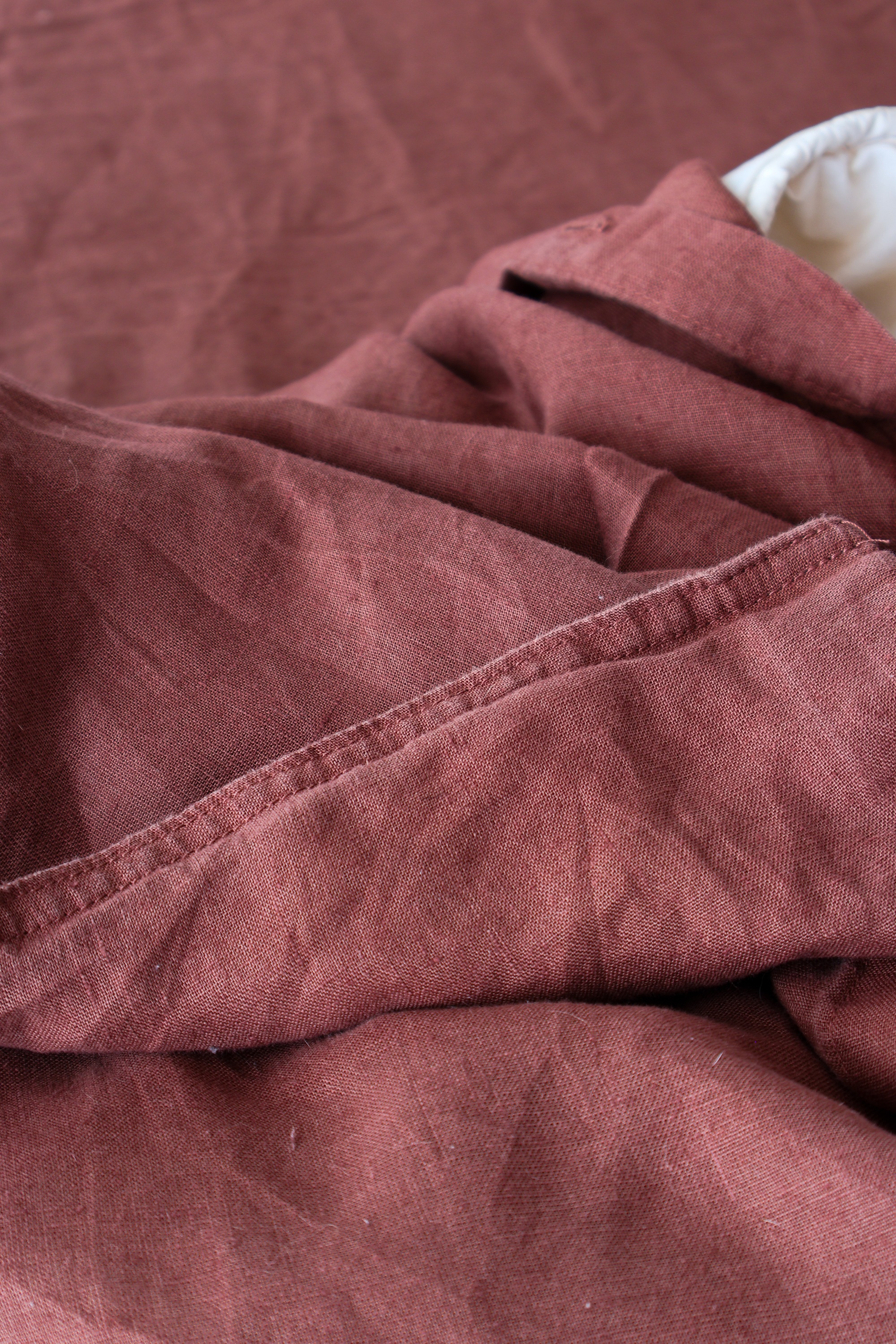 M&s red linen bedding on a bed in a bedroom
