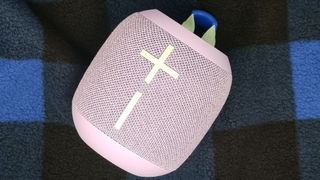 The Ultimate Ears Wonderboom 3 on a chequered background