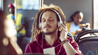 Apple Music vs Amazon Music Unlimited: Man listening to music