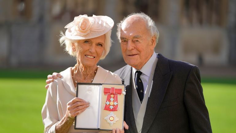 Dame Mary Berry with her husband Paul Hunnings poses with her medal and star following being appointed Dame Commander of the Order of the British Empire (DBE) for services to Broadcasting, the Culinary Arts at an investiture ceremony with Prince Charles, Prince of Wales at Windsor castle on October 20, 2021 in Windsor, England.