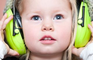 child wearing ear defenders