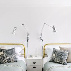 white bedroom with beds and lamps