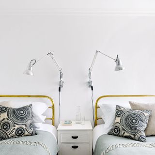 white bedroom with beds and lamps