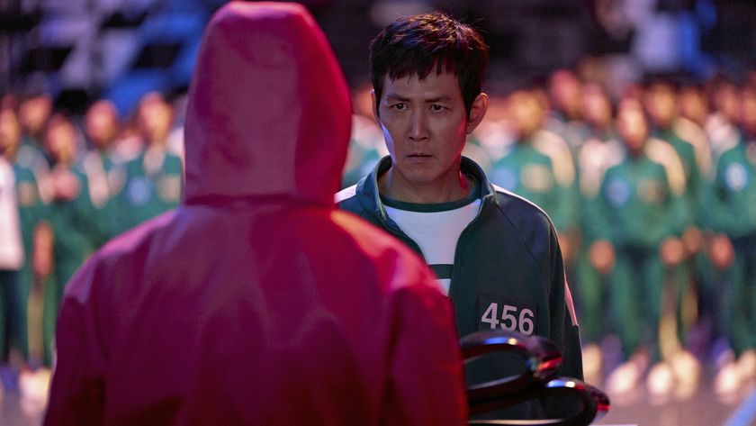 Seong Gi-hun staring intently at a Squid Game soldier in Squid Game season 2