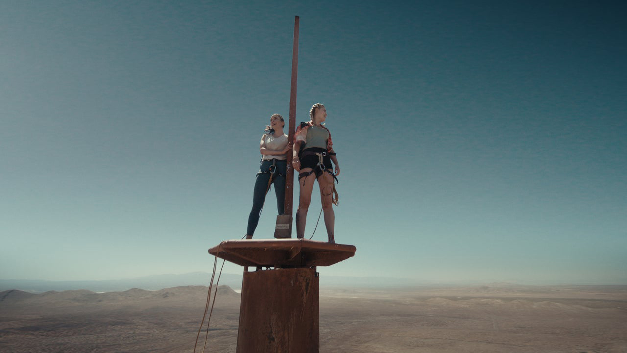 A still from the movie Fall of two characters stood at the top of a tower in the desert