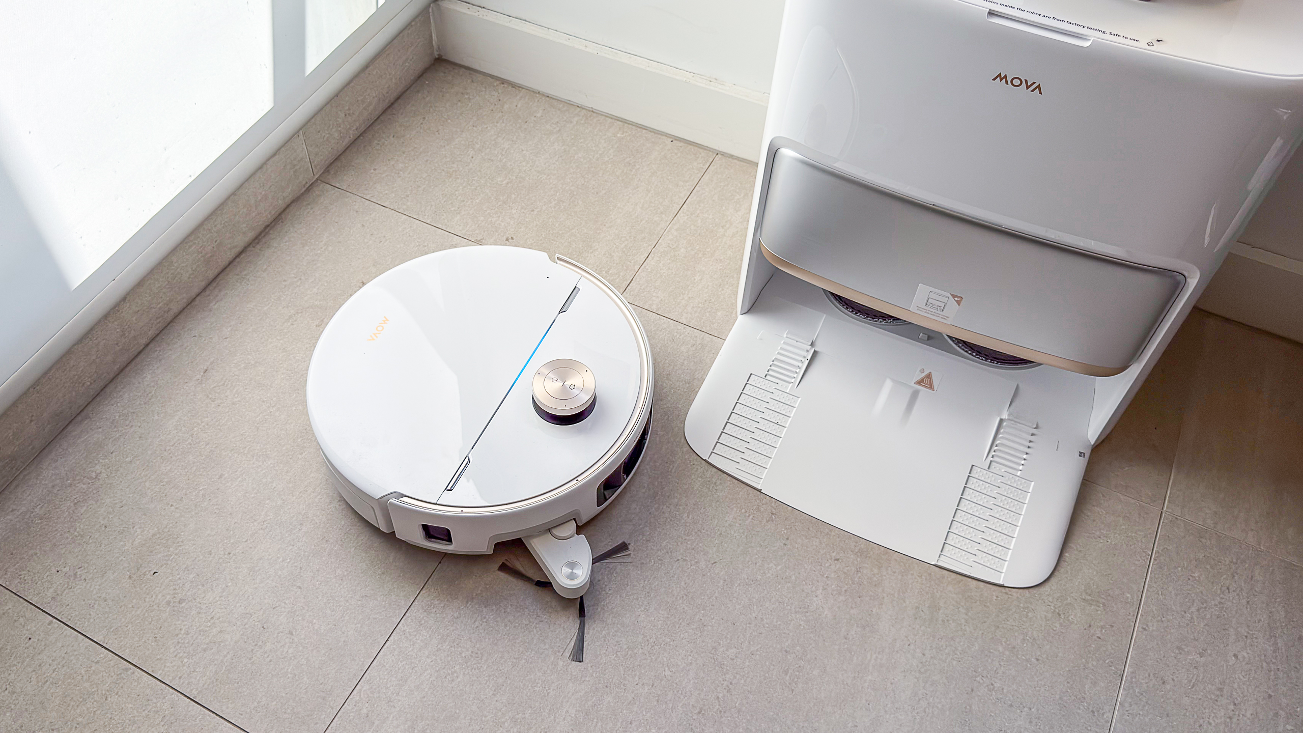 Mova V70 Ultra Complete robot cleaning with side brush extended around its dock