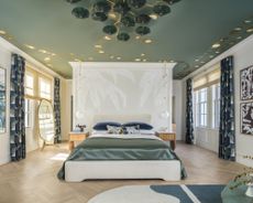 bedroom with mural on the ceiling