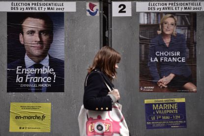 Posters for French presidential candidates Emmanuel Macron and Marine Le Pen.