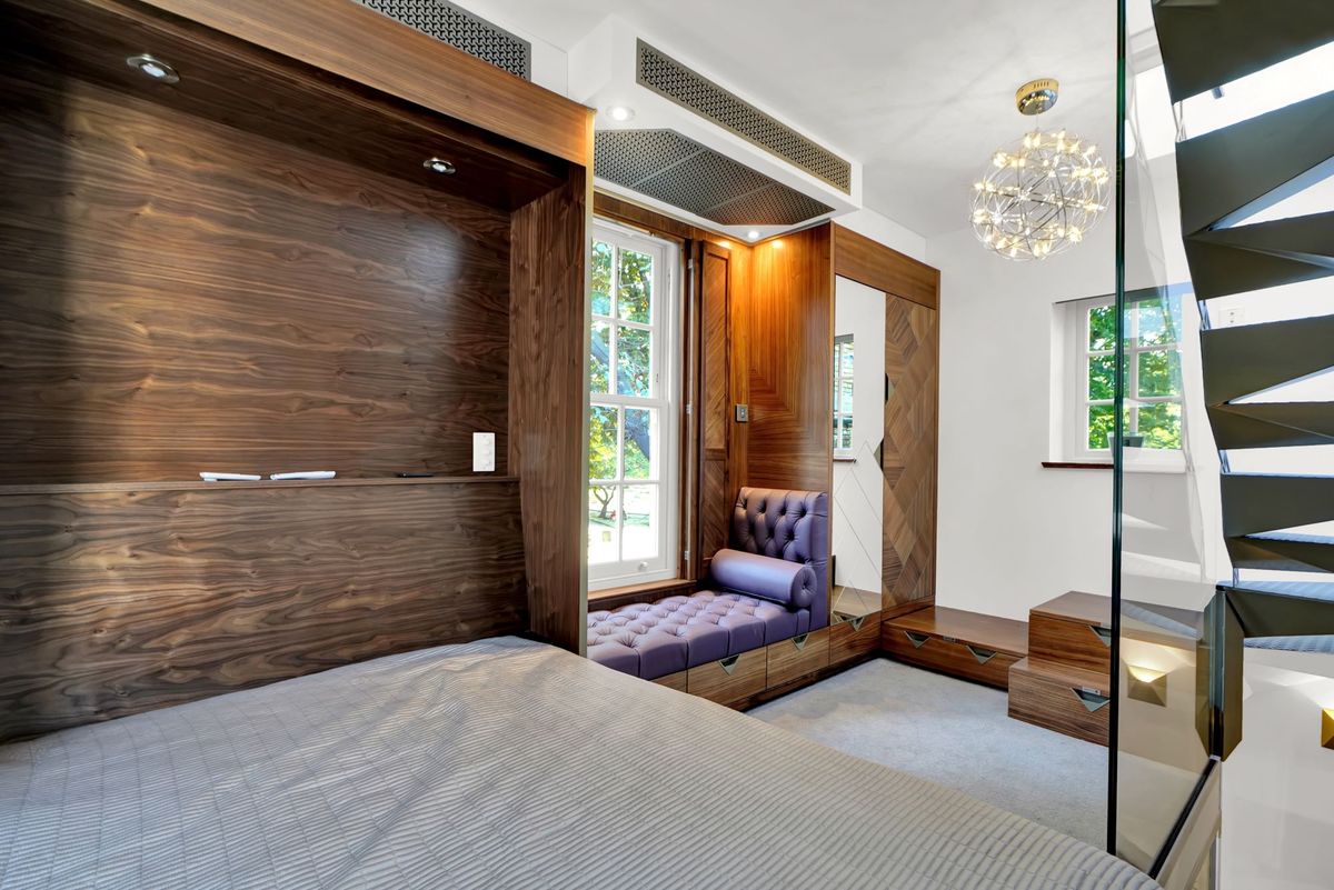 A bedroom with storage area inside the small home