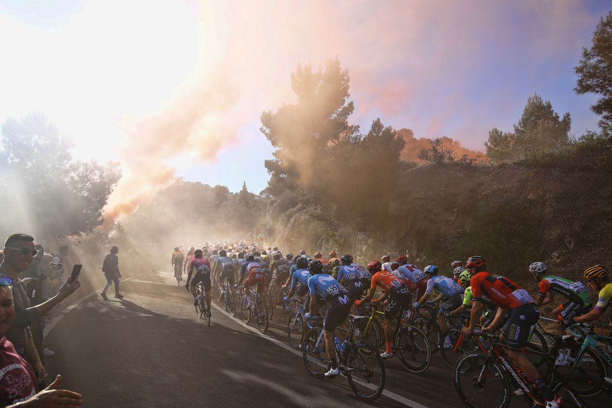 The riders head into the smoke on the Capo Berta