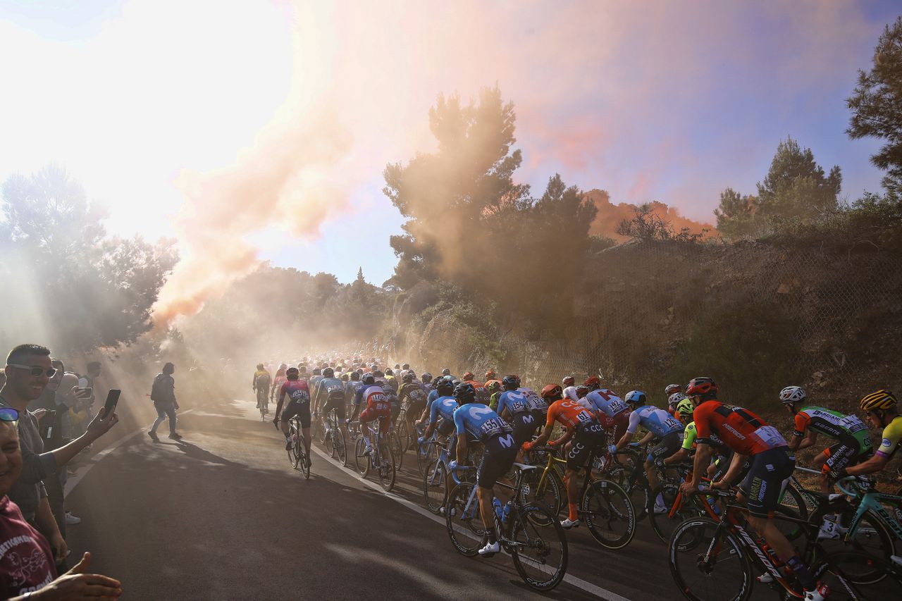 The riders head into the smoke on the Capo Berta
