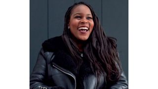 Image of Samantha Jameson smiling with brunette braids and wearing a black aviator jacket