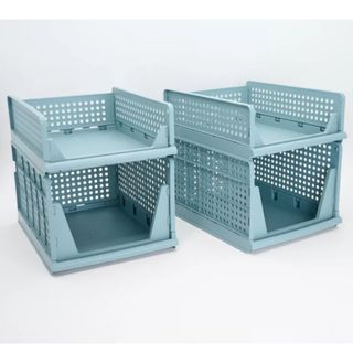 four light blue plastic stackable storage crates on a white background