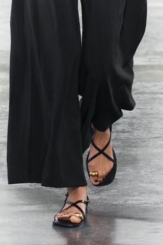 Flat strappy sandals with metal embellishment