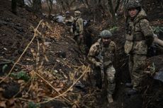 Ukrainian soldiers along trenches, which are covered in mud after the rain on November 6, 2023 in Vuhledar, Ukraine