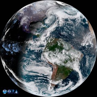 A view of Earth, half in darkness, with a powerful white spiral storm heading over the U.S. East Coast.