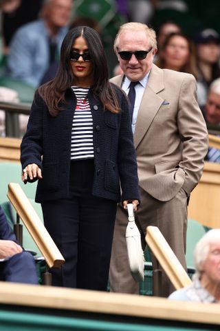 US-Mexican actress Salma Hayek and French businessman François-Henri Pinault arrive on Centre Court to watch the fourth round tennis matches on the seventh day of the 2024 Wimbledon Championships at The All England Lawn Tennis and Croquet Club in Wimbledon, southwest London, on July 7, 2024.