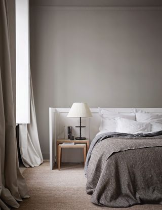Beige grey bedroom with painted walls and soft floor length curtains