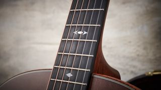 Close up of an acoustic guitar fingerboard