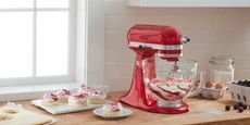 Image of best stand mixer, the KitcheAid Artisan on countertop with cakes 