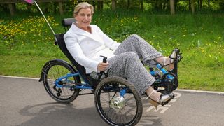 Sophie, Duchess Of Edinburgh, rides an adaptive tricycle during a visit to The Seashell Trust