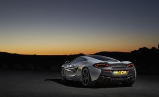 A photo of the McLaren with a sunset backdrop.