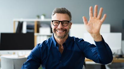 A man happily waves hello (or goodbye).