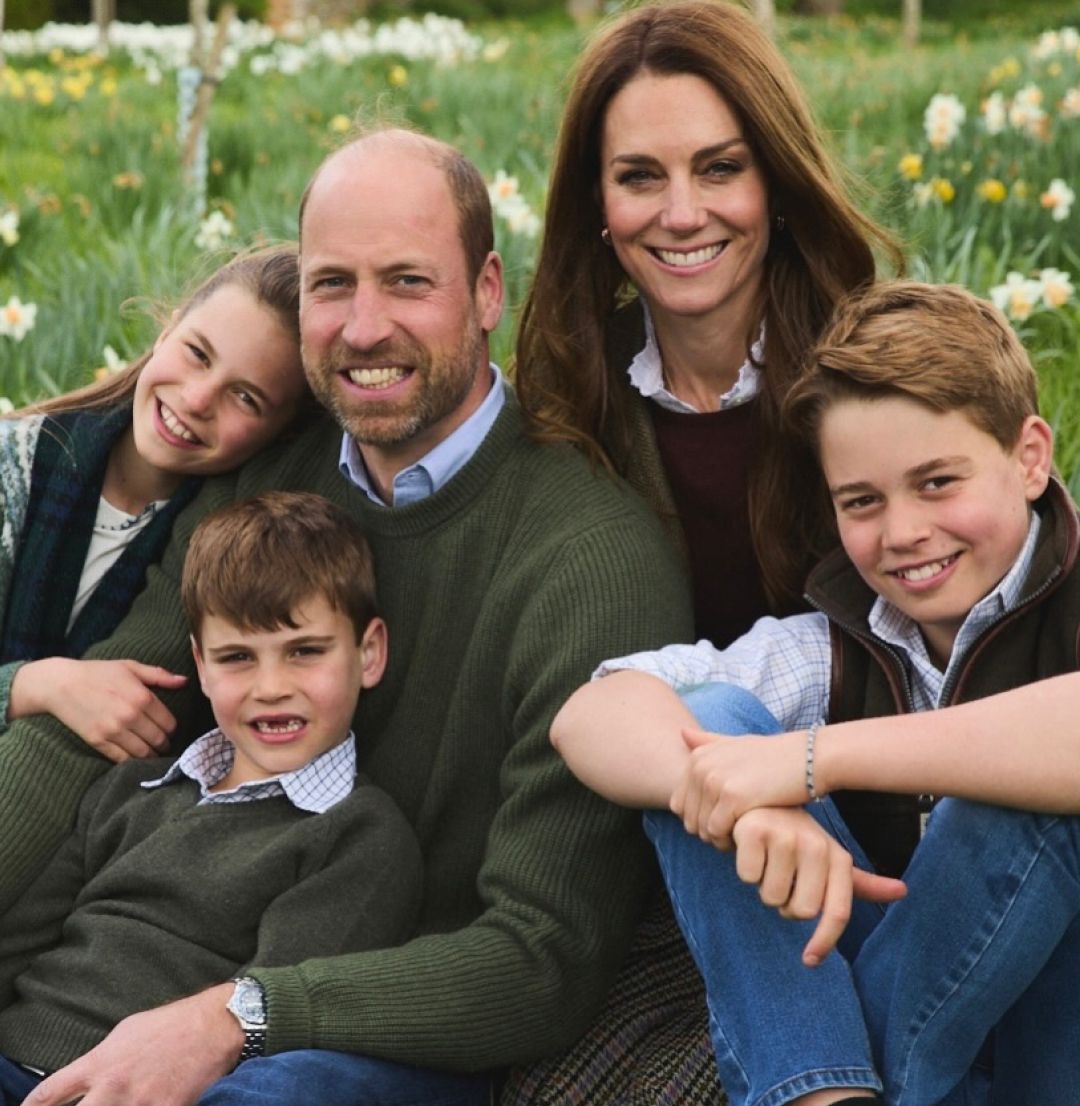 Prince William, Princess Kate, Princess Charlotte, Prince Louis and Prince George sitting in a field of flowers